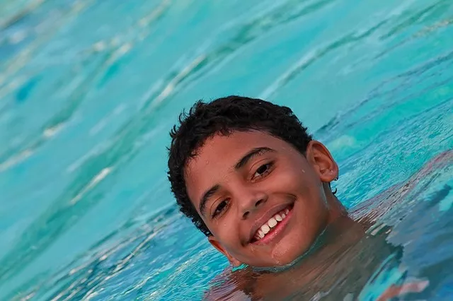 Boy smiling in a pool