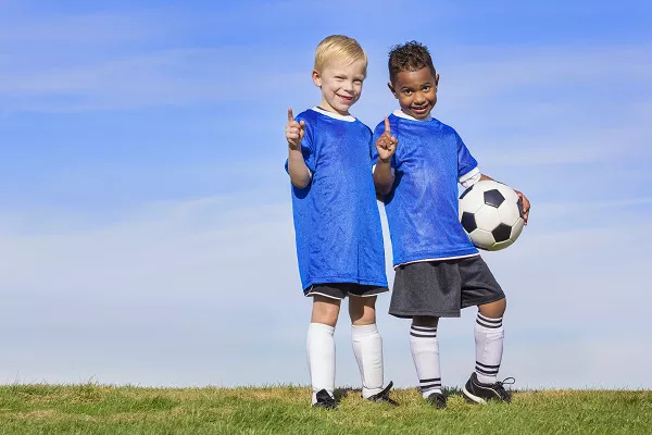 two kids on a soccer field