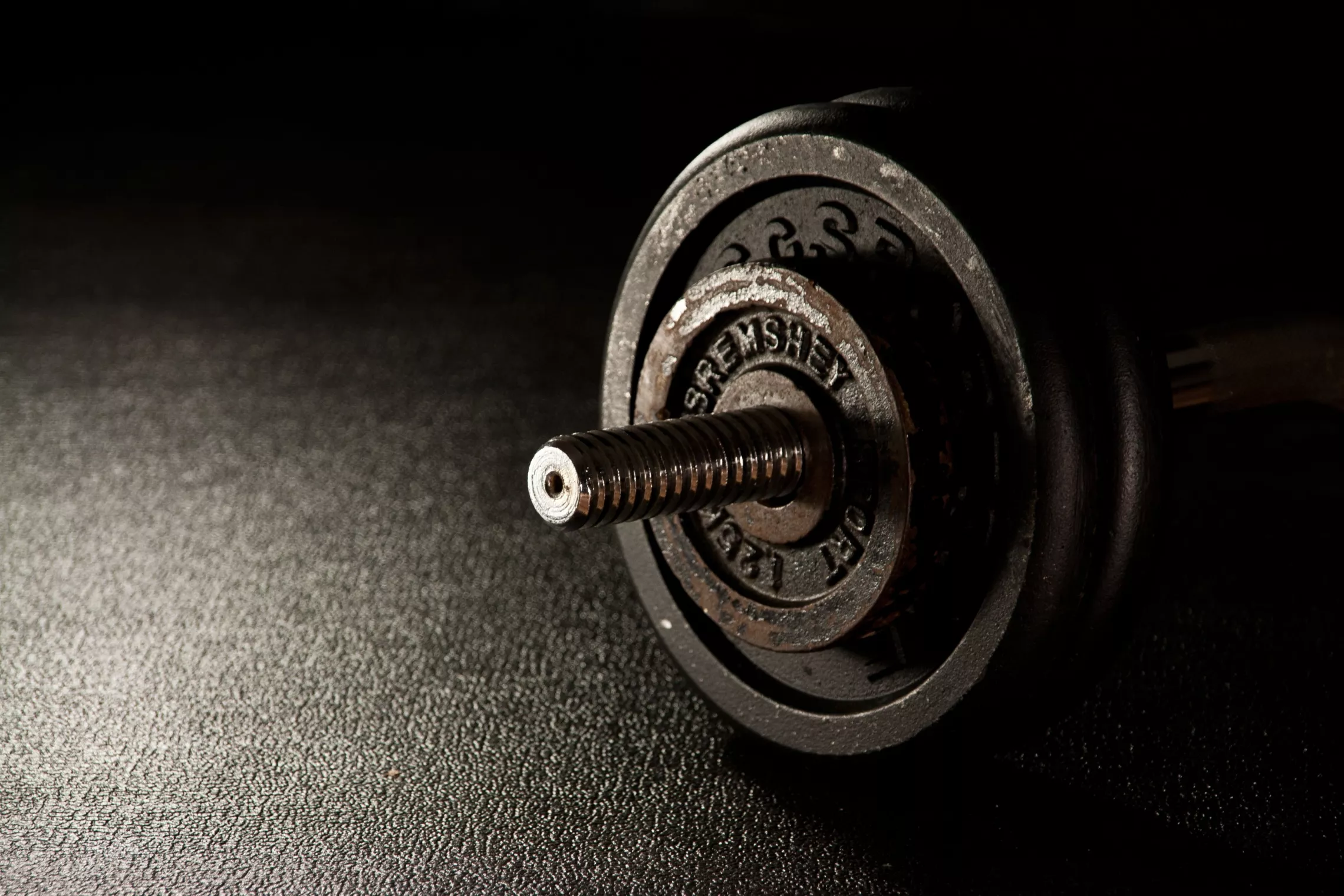 Youth group training 201. Dumbbell on Dark Background