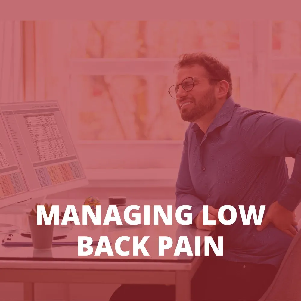 man at a desk holding his lower back in pain